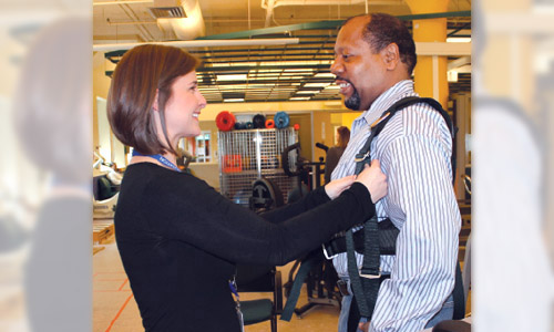 Emily Beus, PT, DPT, works with a patient in the computerized balance system at Magee Riverfront Outpatient Center in Philadelphia. (Photo courtesy Magee Rehabilitation.)